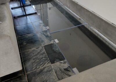 Modern living room with a glass floor design, revealing a space underneath. Stylish and contemporary.