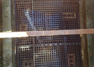 Grid structure with wooden supports over a water collection area.