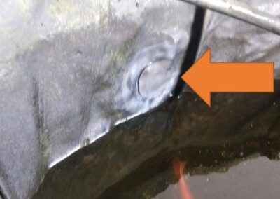 Repair seal on pond liner with koi fish visible in the water below.