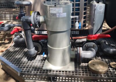 Water filtration system with pipes and connections in outdoor setup. Efficient water management.