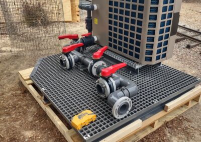 Commercial water cooling system with valves on a raised platform in an outdoor setting.