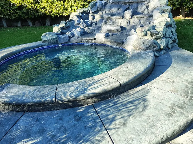 Hillside waterfall into the pool Hillside waterfall into the pool